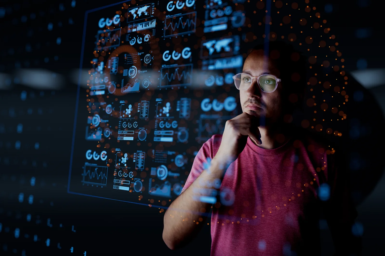 An analyst studying information across a transparent digital display